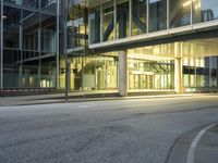 a woman walking down the road in an office building at night in the city center