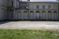 a courtyard with a clock tower and two tall windows is shown on the building's right side