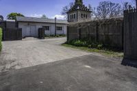 an old church steeple stands next to the entrance gate and gated in area