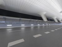 a city street is pictured with the lights reflecting off the buildings'windows of the terminal