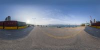 a fisheye view from the street with a lot of traffic and buildings in the background