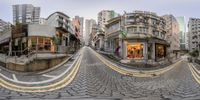 this is a fish eye view of a street corner, with buildings in the background