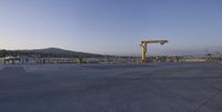 the large crane is overtaking the parking lot at the harborfront park area, which has been closed since