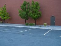 a paved street has been painted light gray, with gray brick walls and concrete edges