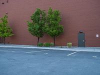 a paved street has been painted light gray, with gray brick walls and concrete edges