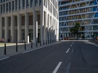 the empty street with bicycles parked in front of the buildings has a sign that says the library on it