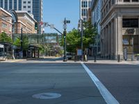 an empty street with buildings and parked cars on the sidewalks and green lanes on the sidewalk