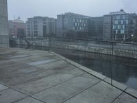 a bridge leads to the river and many other buildings near by on a hazy day