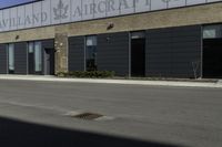 a street in front of a building with a road underneath it that has a sky