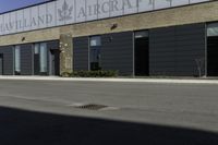 a street in front of a building with a road underneath it that has a sky