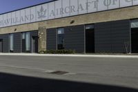 a street in front of a building with a road underneath it that has a sky