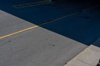 an empty parking lot with no cars on the ground and two people standing underneath it