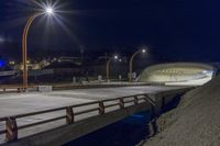 the road bridge is made of concrete and has several lights on it's sides