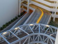 a view of a road and an overpass with traffic passing through it by buildings