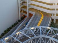 a view of a road and an overpass with traffic passing through it by buildings