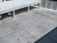 two parked vehicles sitting in the middle of a parking garage lot with a ramp going up