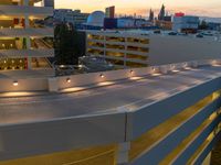 a view of a road and an overpass with traffic passing through it by buildings