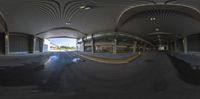 the inside of an airport showing puddles of water on the ground and a terminal with overhead walkway and platforms