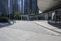 a person sitting at the bench in front of a mall that is empty of people