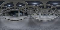 an image of a very high building with a curved corridor in front of it at night