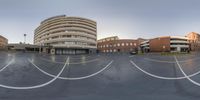 a circular photo of a building in a large parking lot with a stop sign in the center