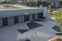 a view of an outside area of an office building with large windows and a circular driveway