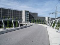 the walkway across from the building is connected with the walkway railings that extends the walkway