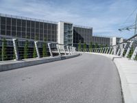 the walkway across from the building is connected with the walkway railings that extends the walkway