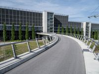 the walkway across from the building is connected with the walkway railings that extends the walkway