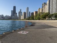 a lake in a city with high rise buildings and a no parking sign posted on it