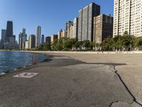 a lake in a city with high rise buildings and a no parking sign posted on it