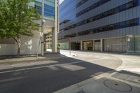 the corner of a city street in a residential area with a car stop and sidewalk