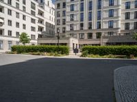 a person is riding on a bike outside an apartment building in brussels, france that is next to the entrance