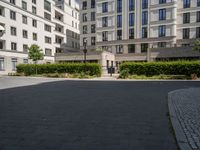 a person is riding on a bike outside an apartment building in brussels, france that is next to the entrance