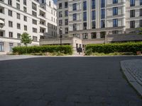 a person is riding on a bike outside an apartment building in brussels, france that is next to the entrance