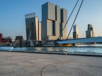 a bridge that has been installed near some buildings by the water's edge by a river