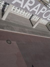 a man riding a skateboard up the side of a wall holding a board in his hands
