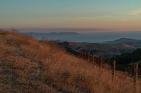 this is an image of a hilly countryside scene at sunset time in the western united states