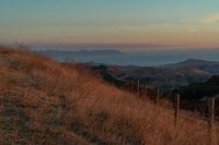 this is an image of a hilly countryside scene at sunset time in the western united states