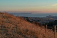 this is an image of a hilly countryside scene at sunset time in the western united states