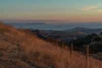 this is an image of a hilly countryside scene at sunset time in the western united states