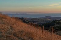 this is an image of a hilly countryside scene at sunset time in the western united states