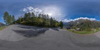 an 360 - view of a skateboarder doing a trick in the mountains and trees