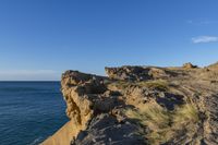 an image of the view from a cliff overlooking the ocean and sky in winter time