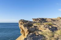 an image of the view from a cliff overlooking the ocean and sky in winter time