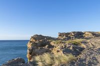 an image of the view from a cliff overlooking the ocean and sky in winter time