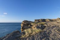 an image of the view from a cliff overlooking the ocean and sky in winter time