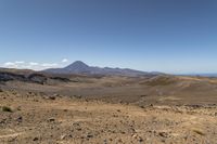 a barren area with rocks and rocks in front of mountains that are in the distance