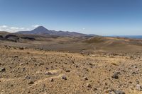 a barren area with rocks and rocks in front of mountains that are in the distance