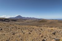 a barren area with rocks and rocks in front of mountains that are in the distance